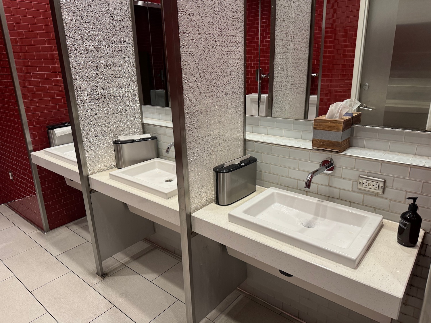 a bathroom with sinks and mirrors