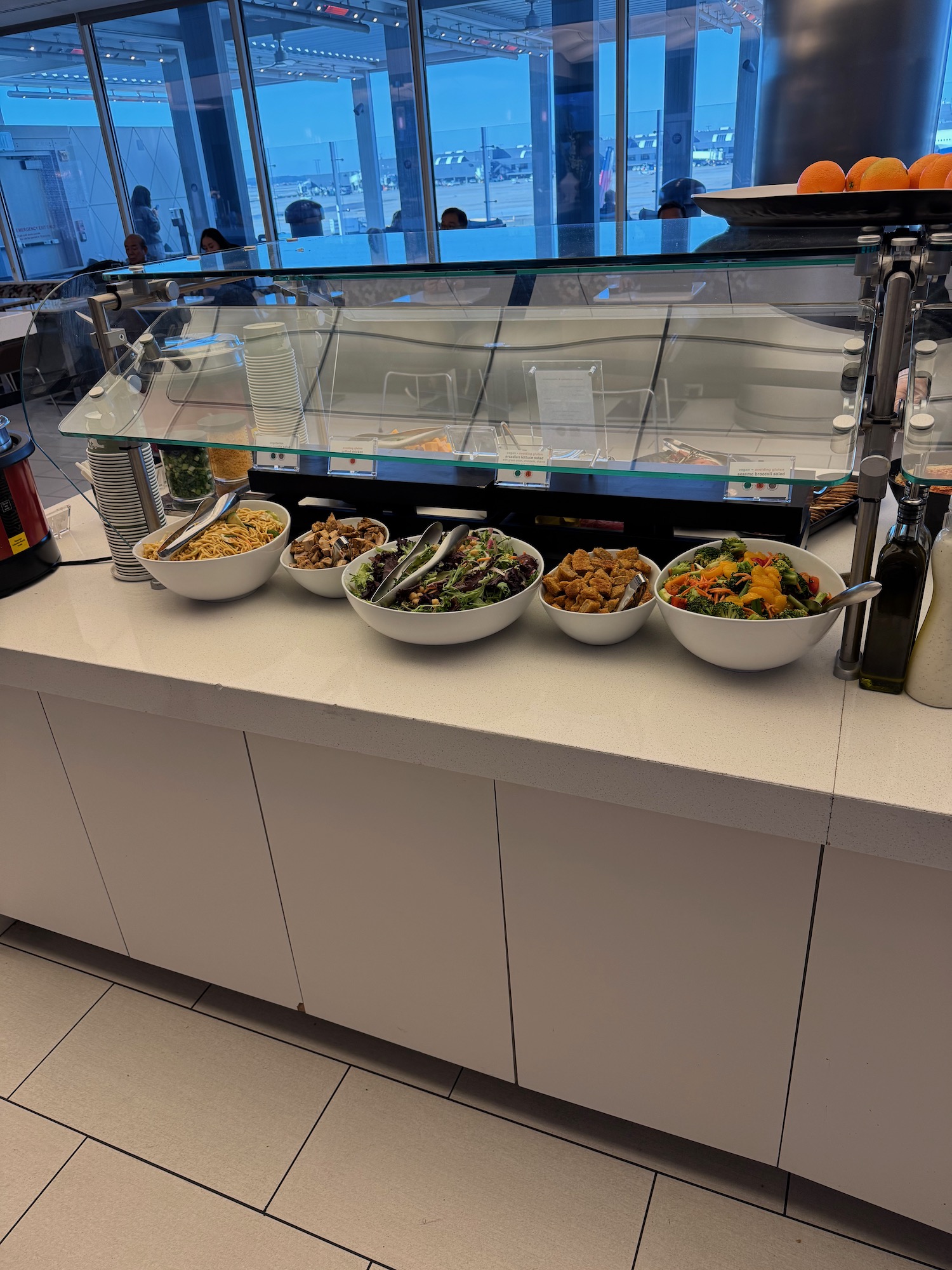 a row of bowls of food on a counter