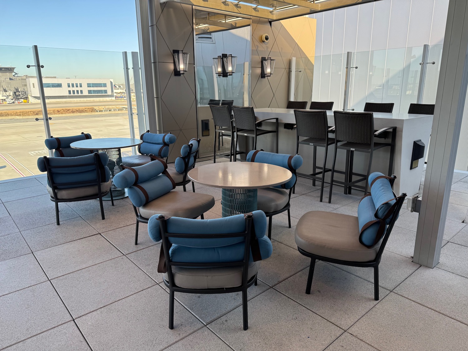 a patio with chairs and tables