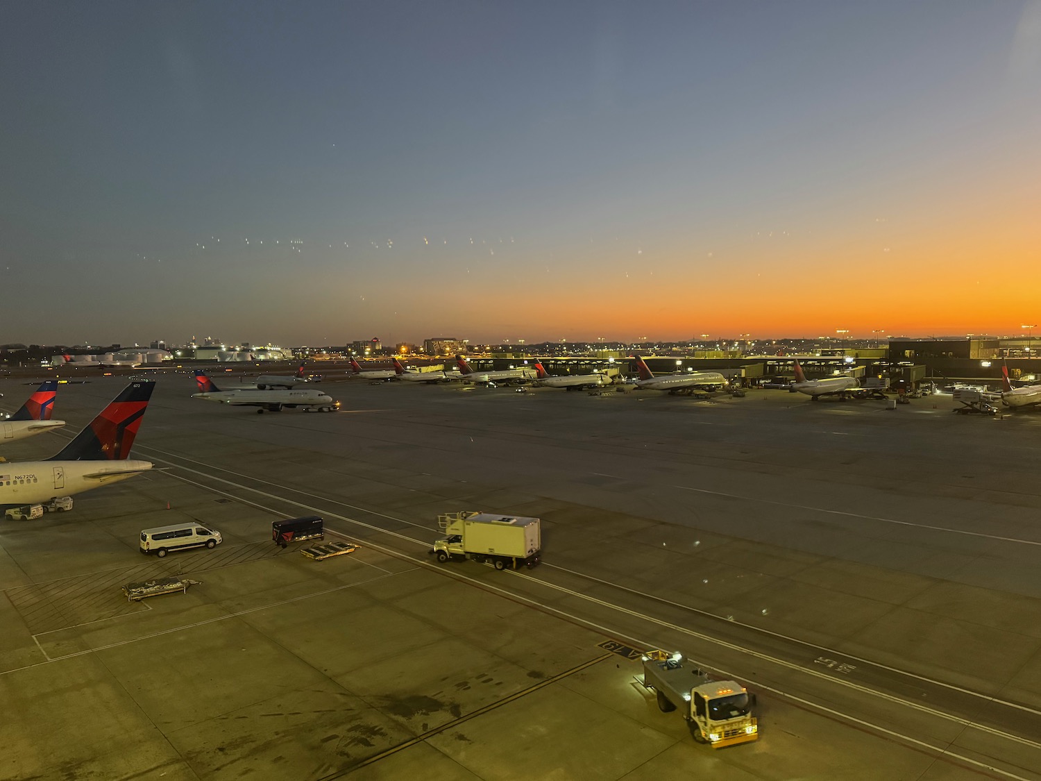 an airport with airplanes and trucks