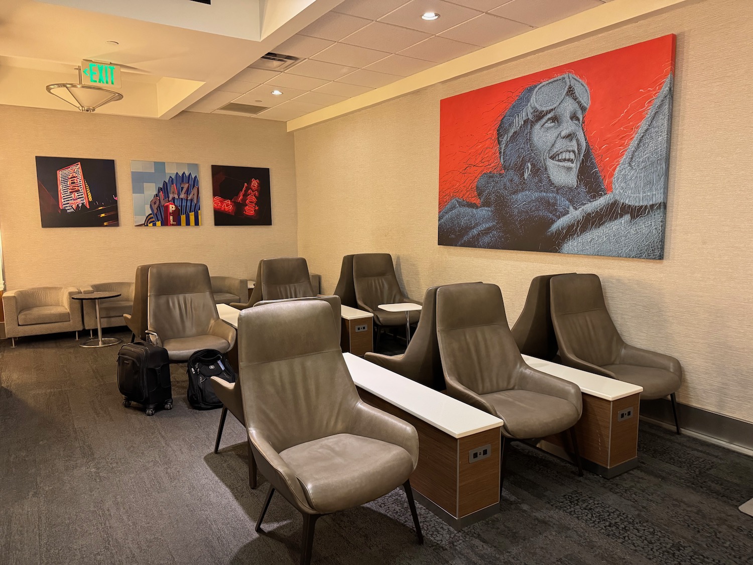 a room with chairs and a painting on the wall