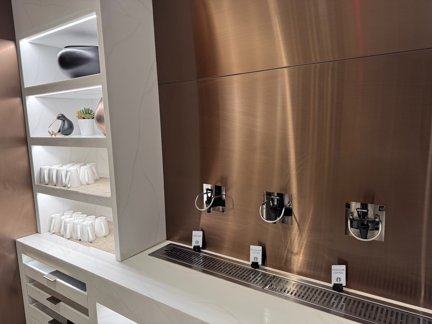 a room with a sink and shelves