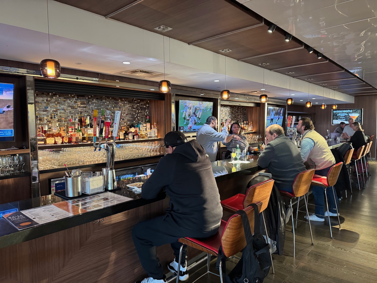 a group of people sitting at a bar