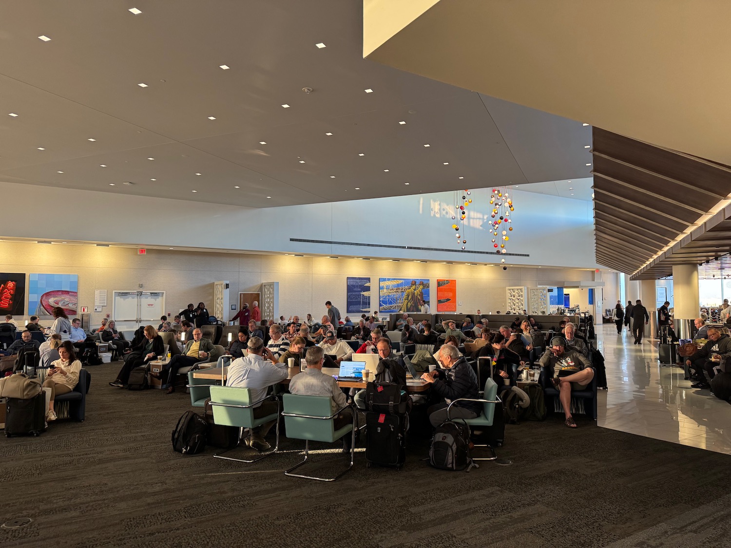 a group of people sitting in chairs in a large room