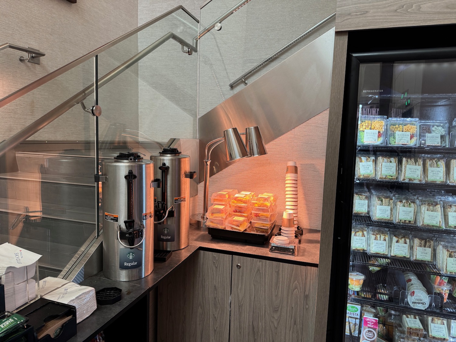 a counter with a glass staircase and a container of food