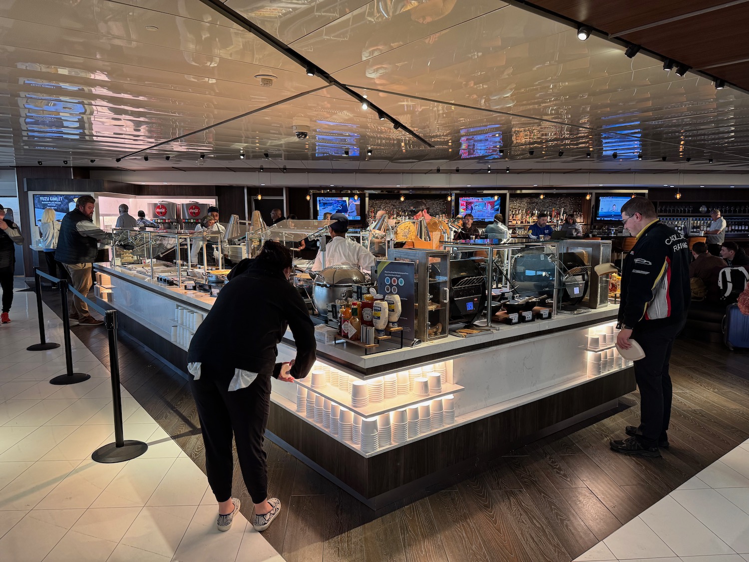 people standing at a counter in a restaurant