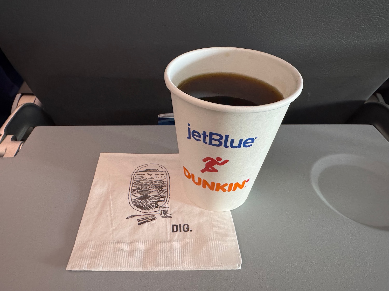 a paper cup of coffee on a napkin
