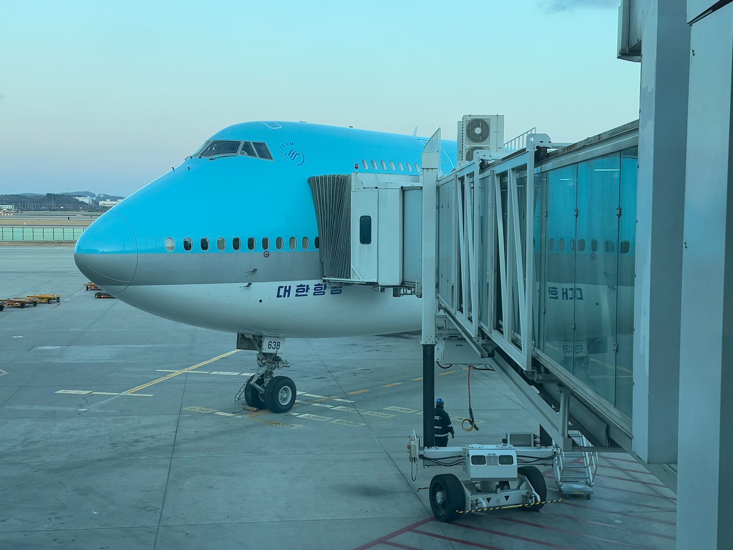 a blue airplane at an airport