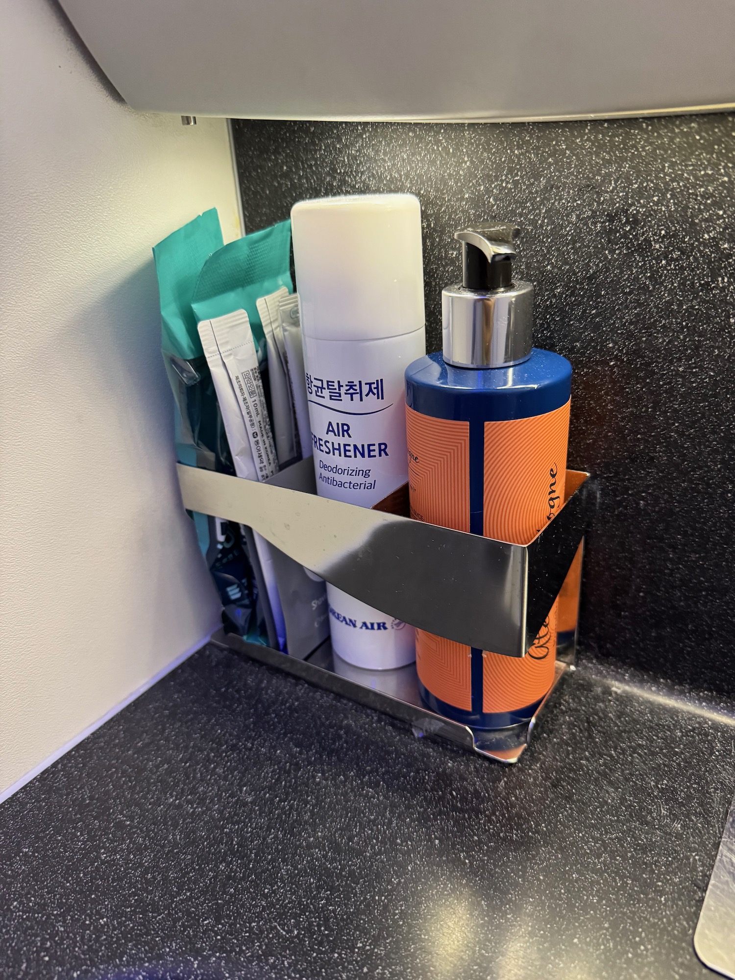 a group of toiletries in a metal holder