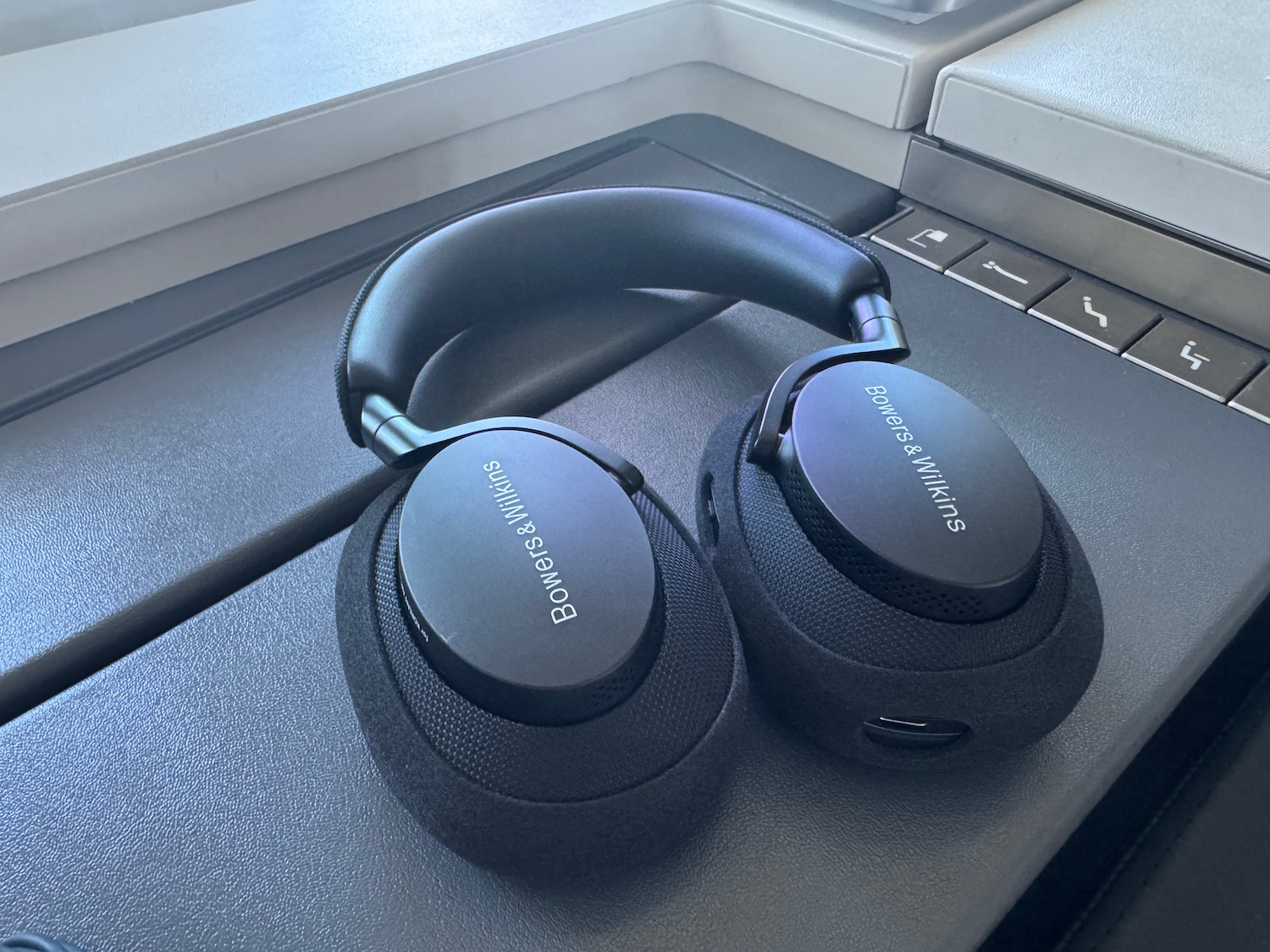 a pair of black headphones on a grey surface