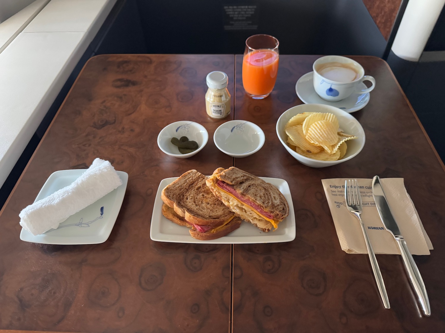 a table with plates of food and a drink