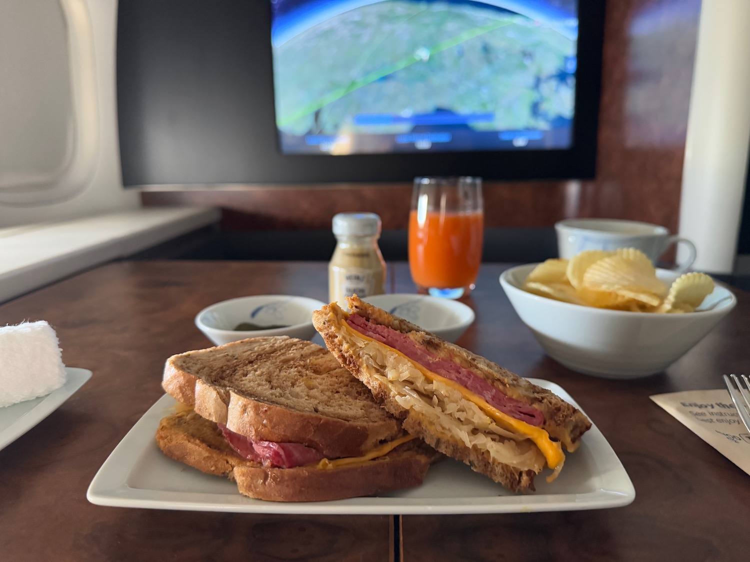 a plate of sandwiches and a television on a table