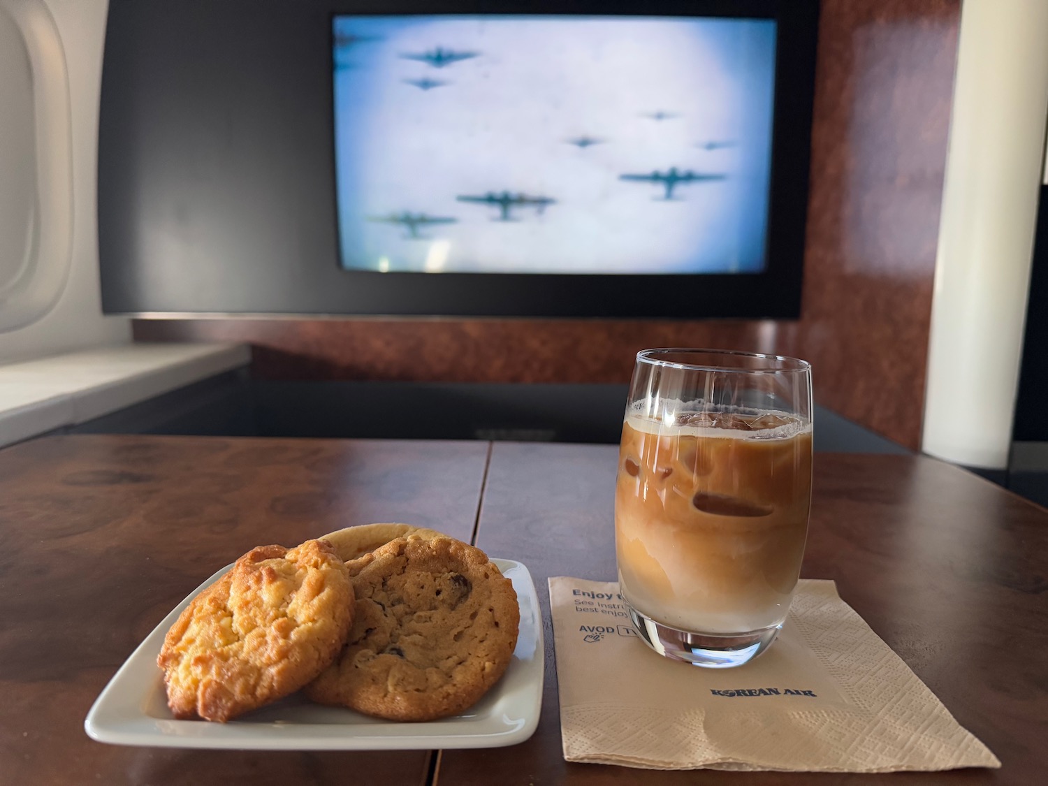 a plate of cookies and a glass of liquid on a table