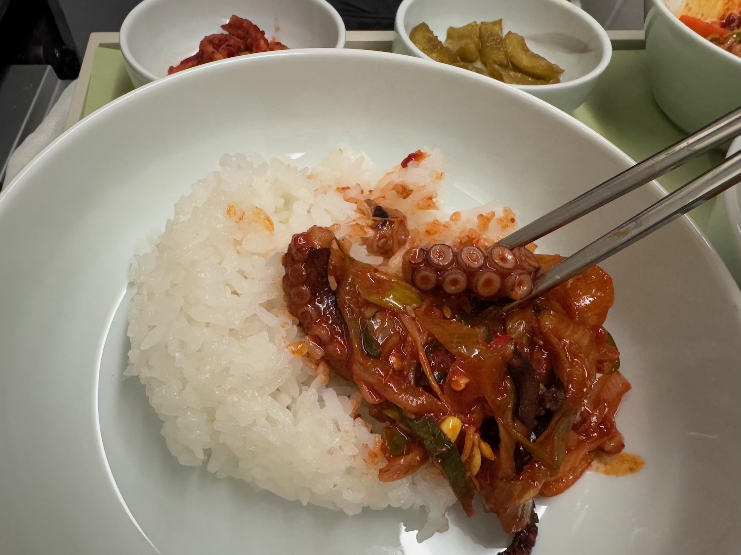 a plate of food with chopsticks