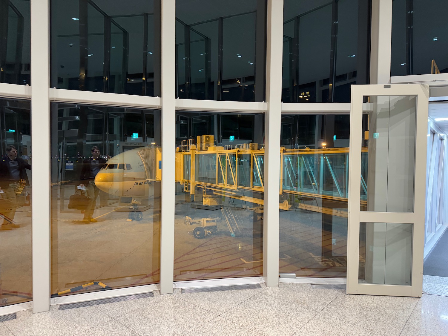 a window of a building with a plane in the background