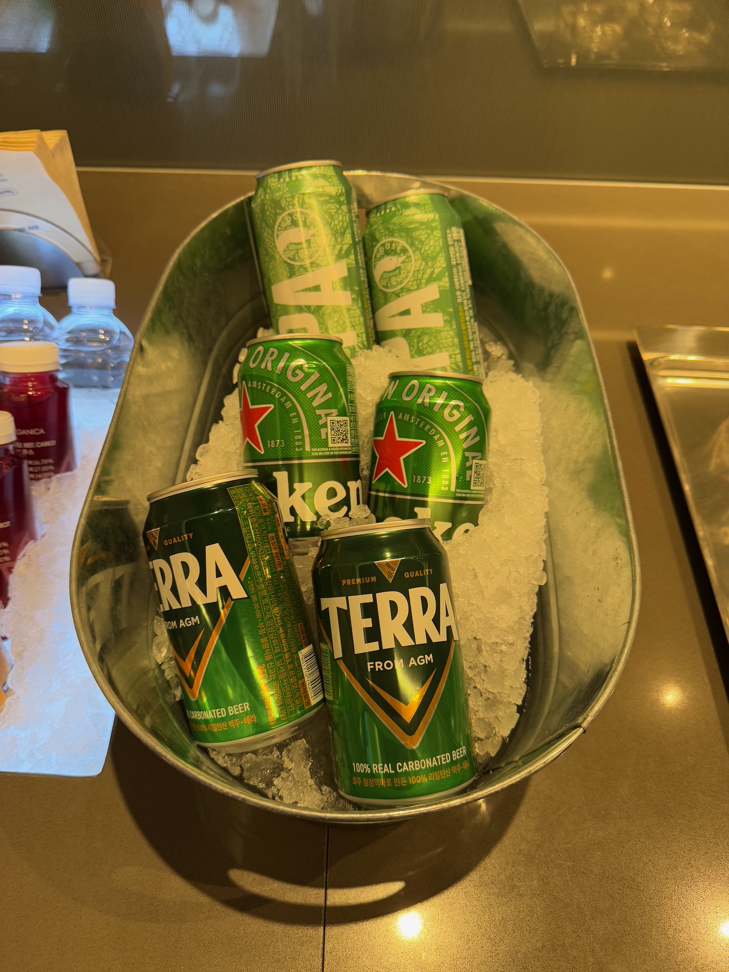 a bucket of cans and cans of beer