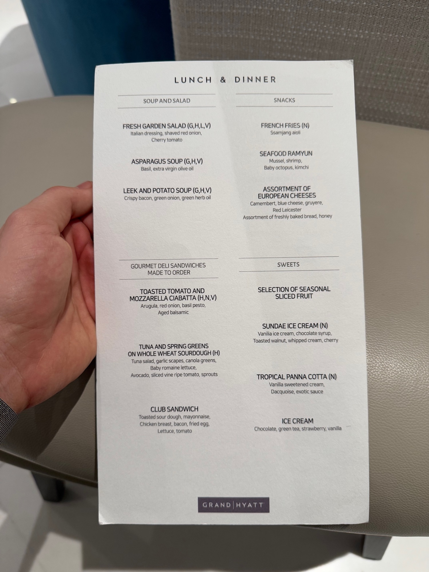 a hand holding a paper with text