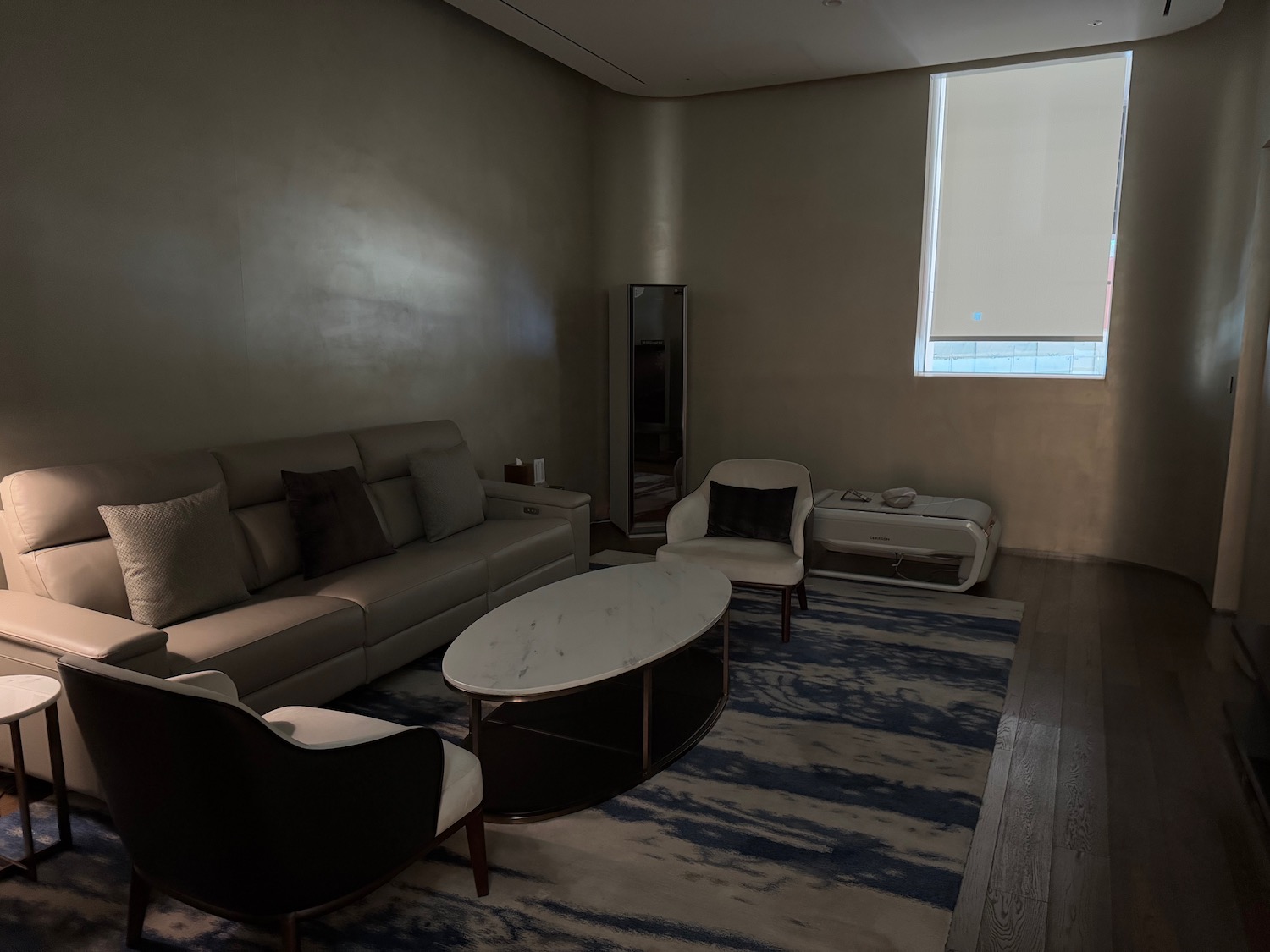 a room with a couch and chairs