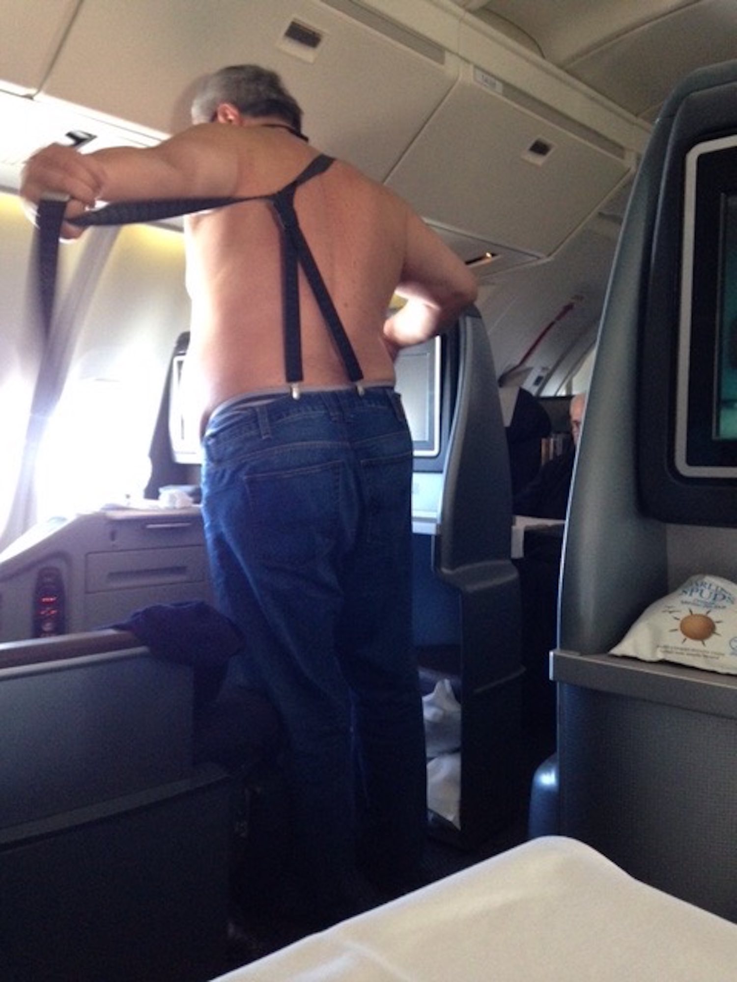 a man in a suspender on an airplane