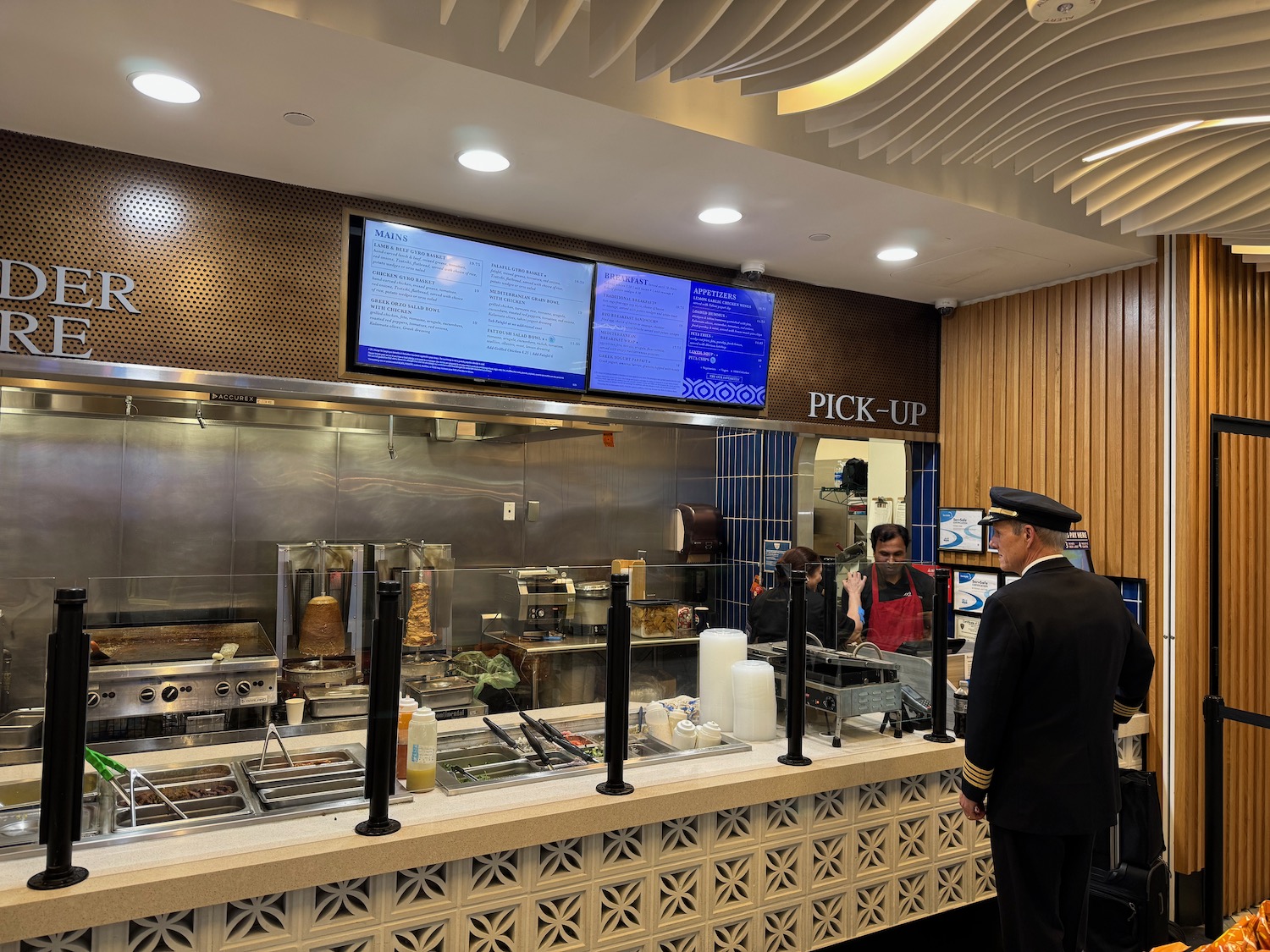a man in uniform standing in front of a counter