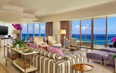 a living room with a view of the ocean