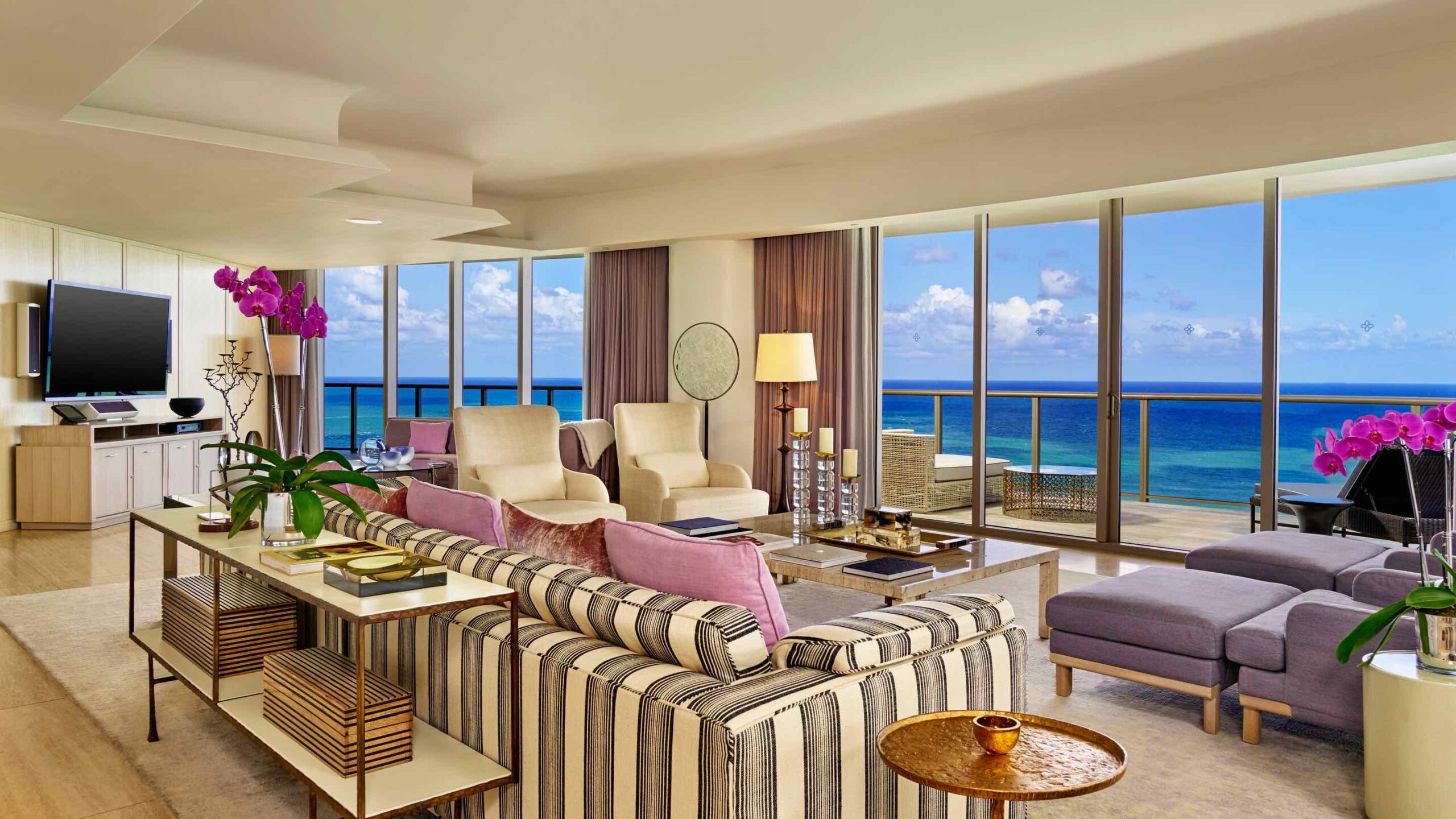 a living room with a view of the ocean