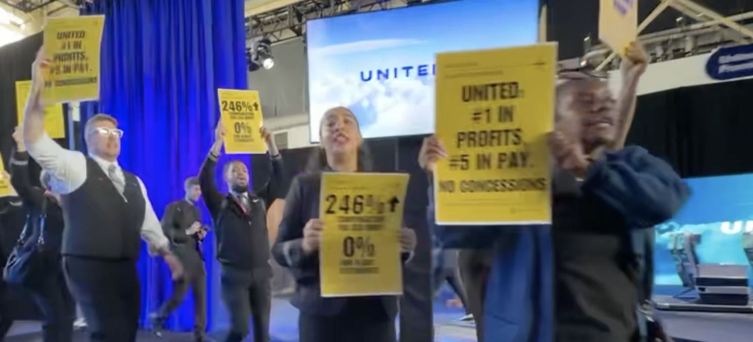 a group of people holding signs