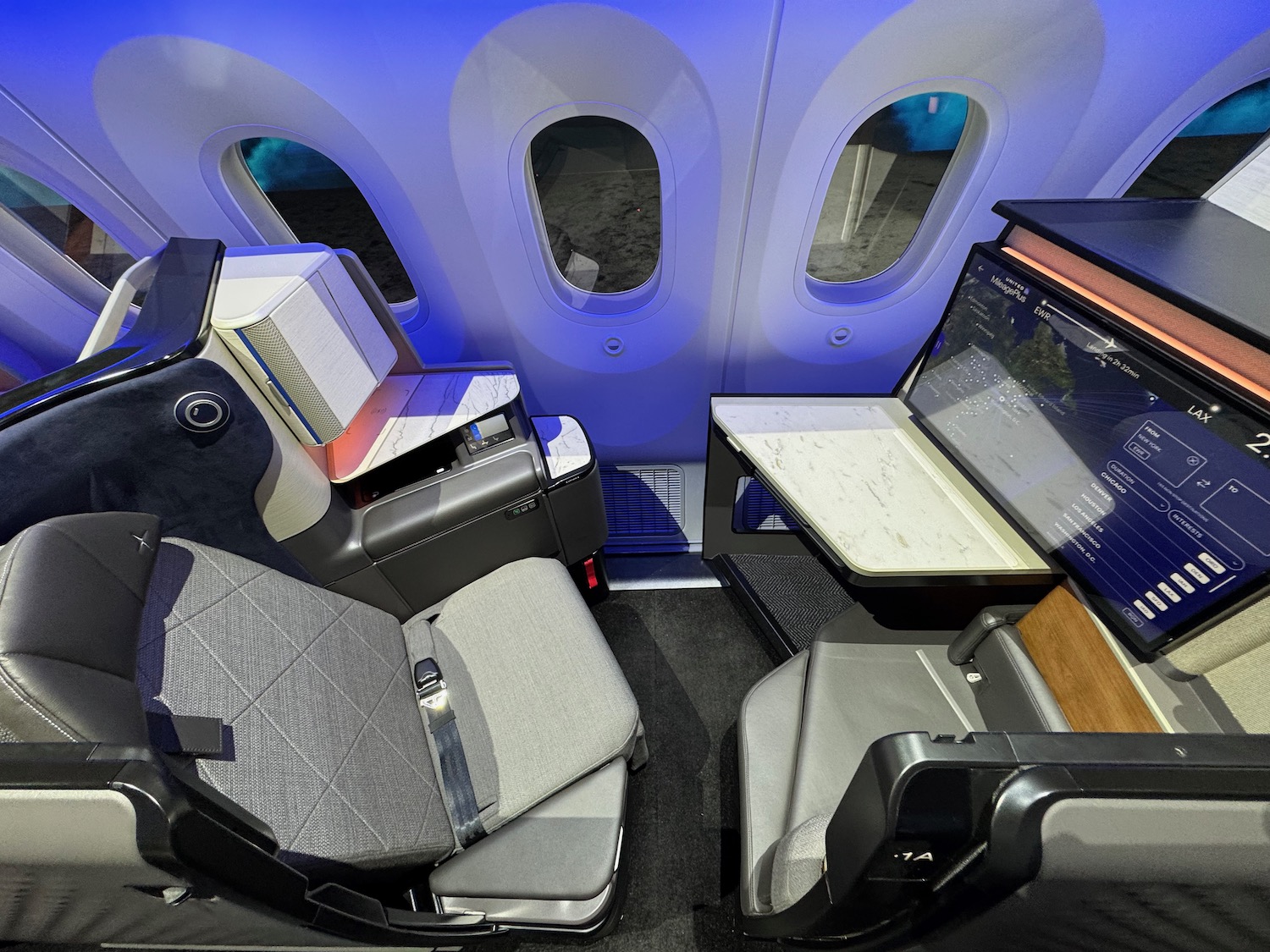a seat and desk in an airplane
