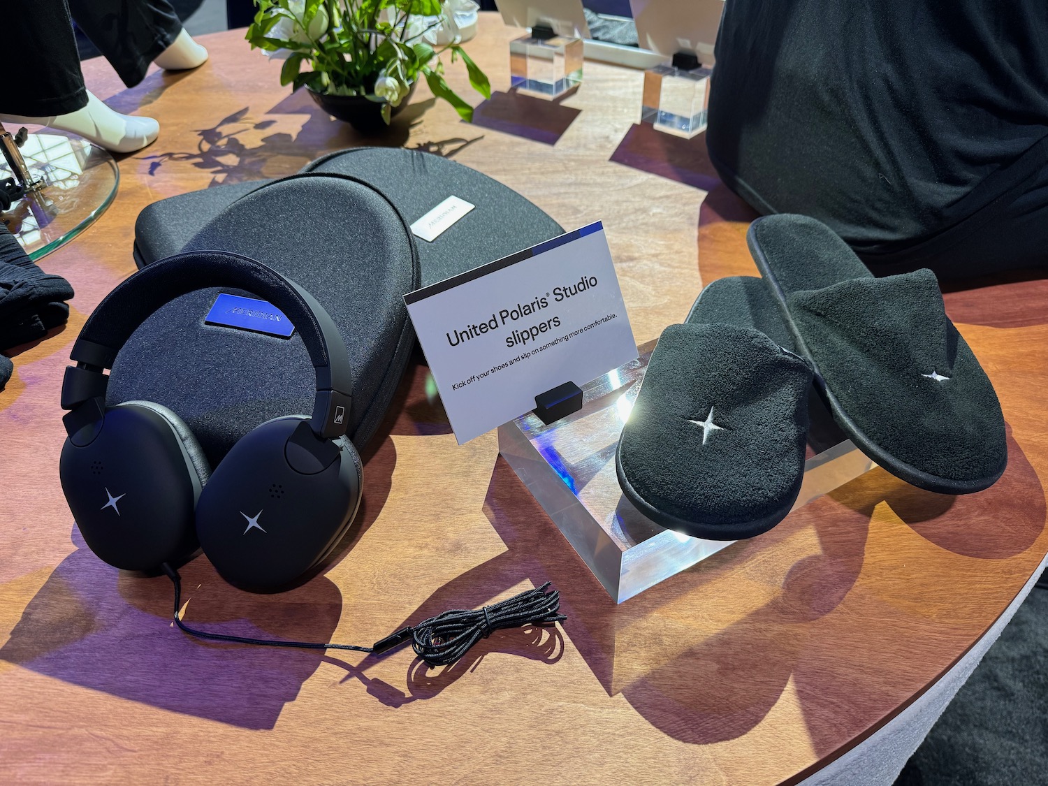 a table with black slippers and headphones