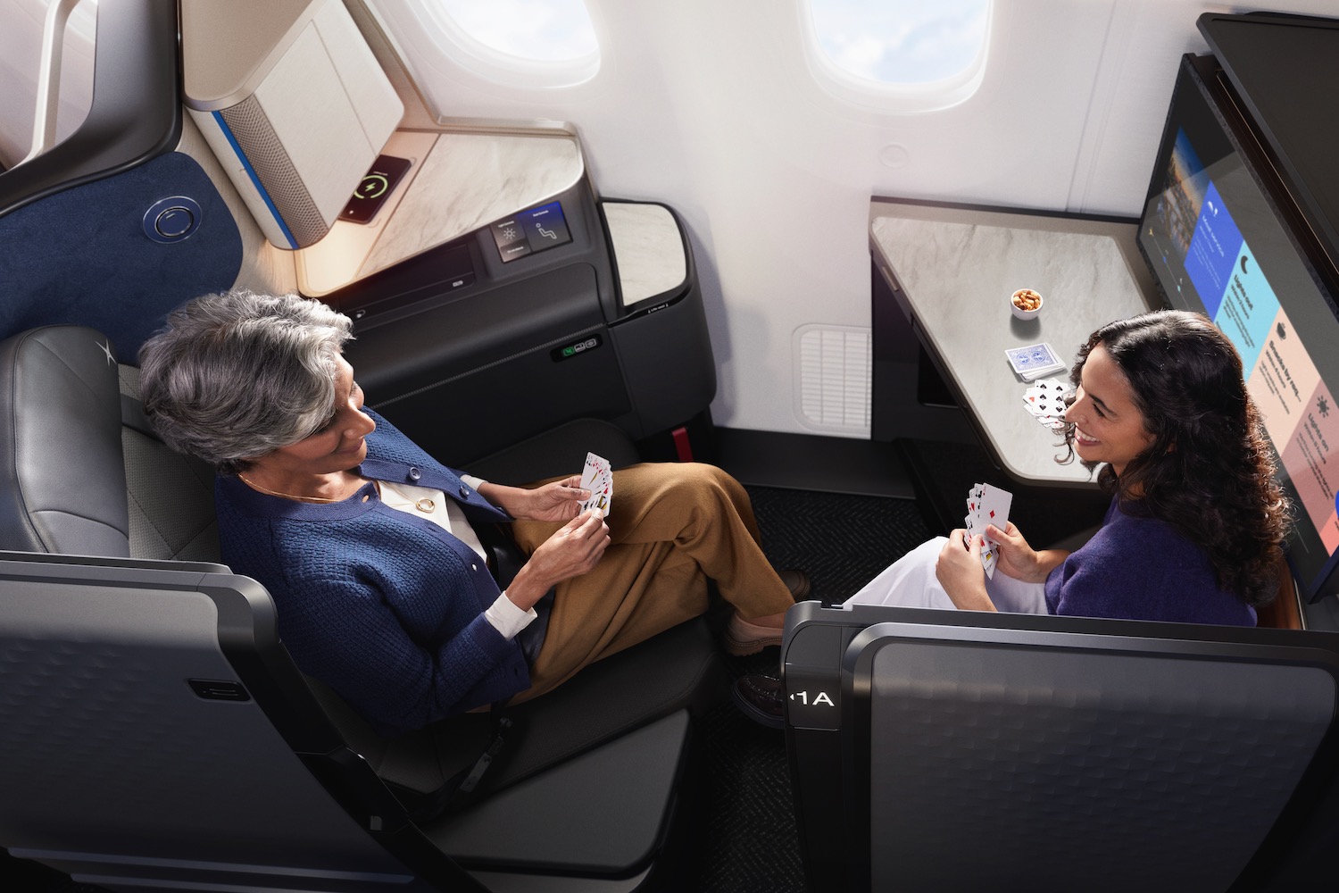 a woman playing cards on an airplane