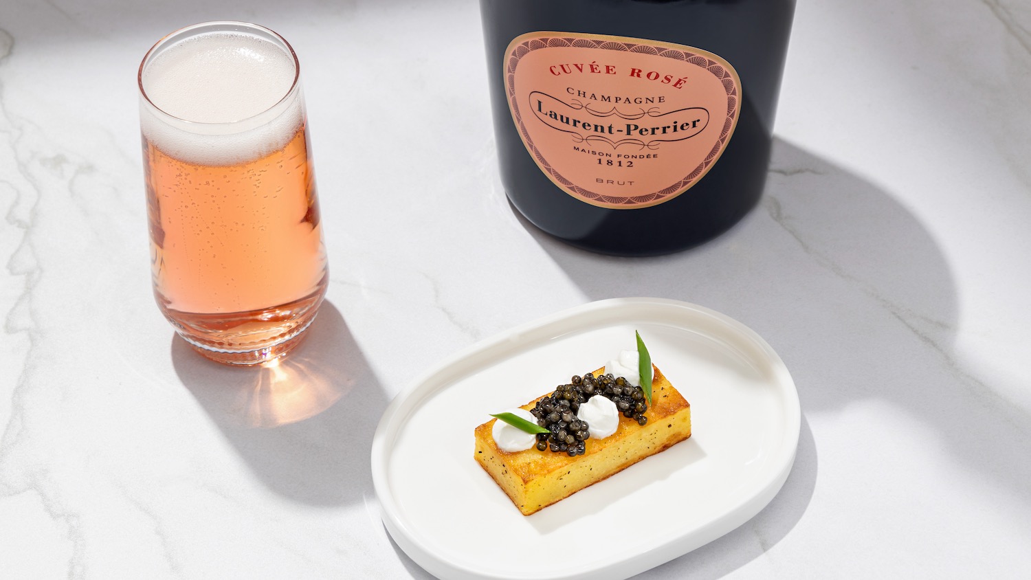 a plate of food and a glass of champagne