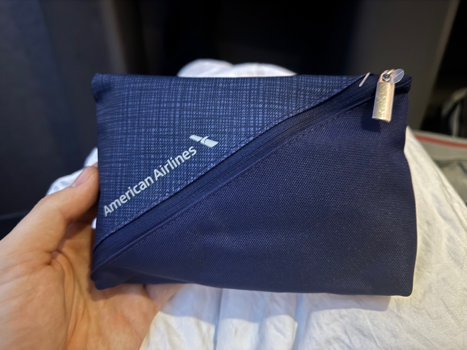 a hand holding a blue bag