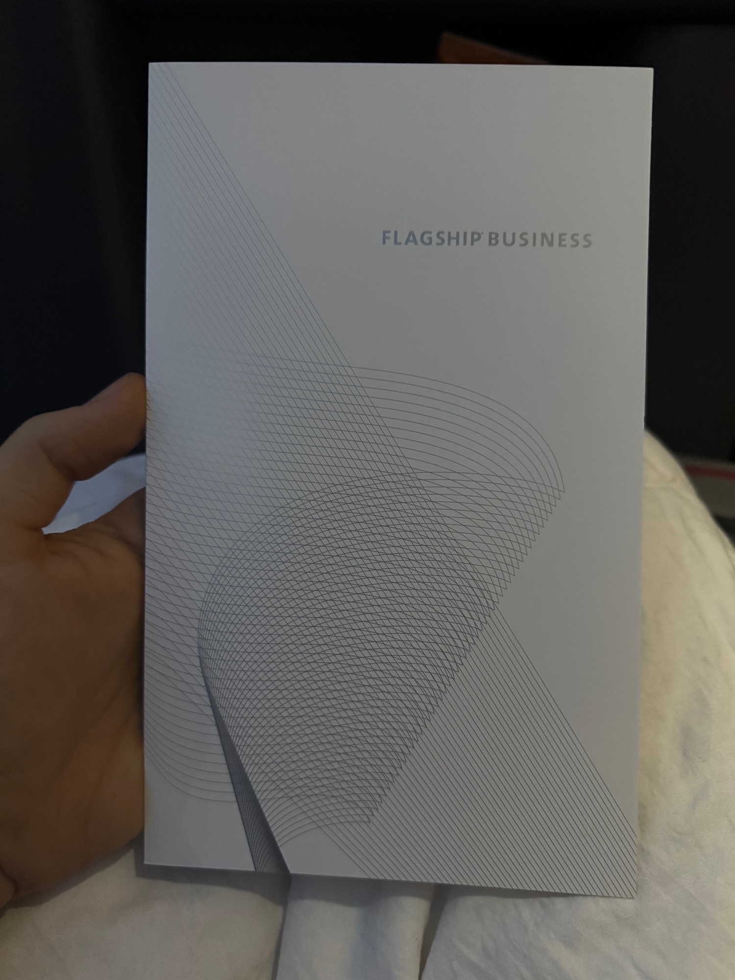 a hand holding a white paper