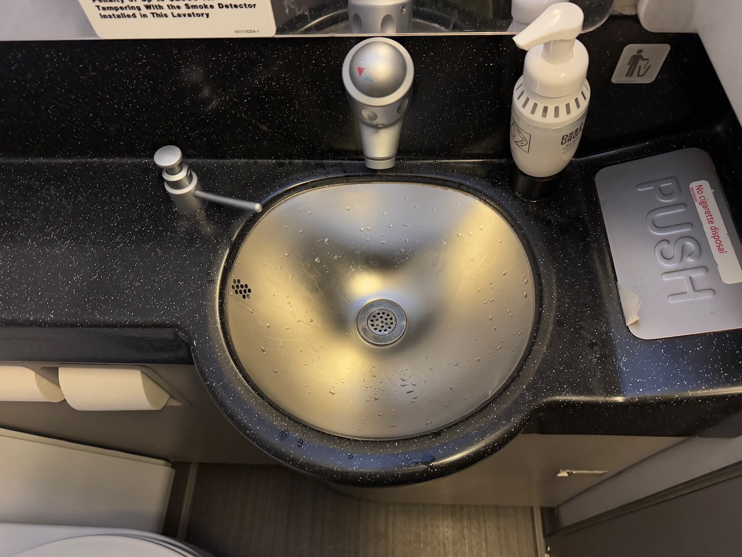 a sink with soap dispensers and soap dispensers