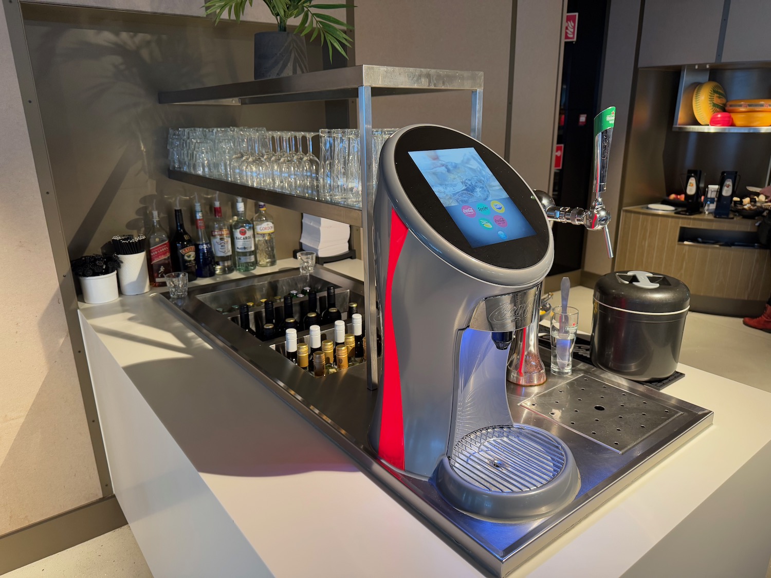 a machine with a screen and a shelf with bottles on it