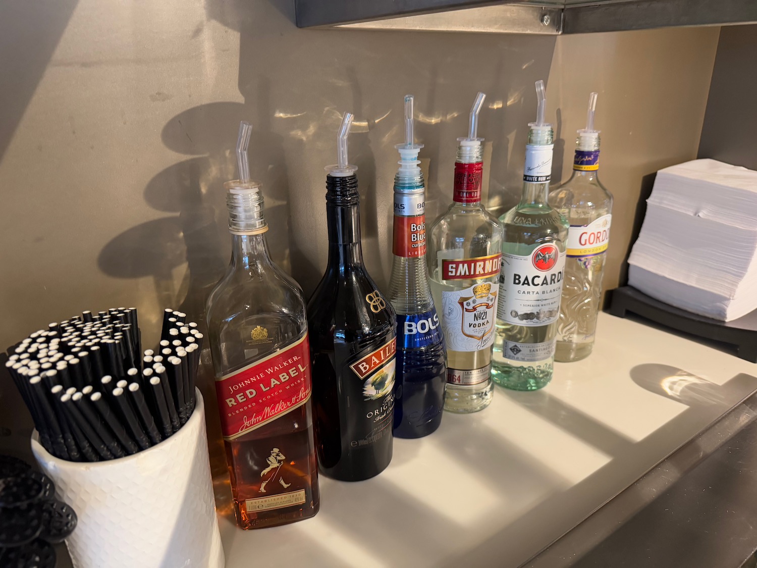 a group of bottles with straws