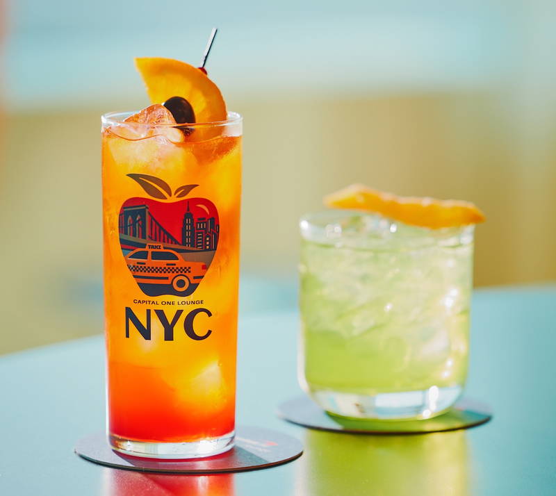 a glass of orange and green liquid next to a glass of orange and green liquid