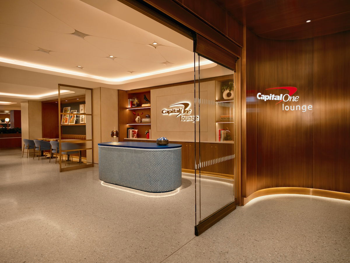 a lobby with a reception desk and a glass door