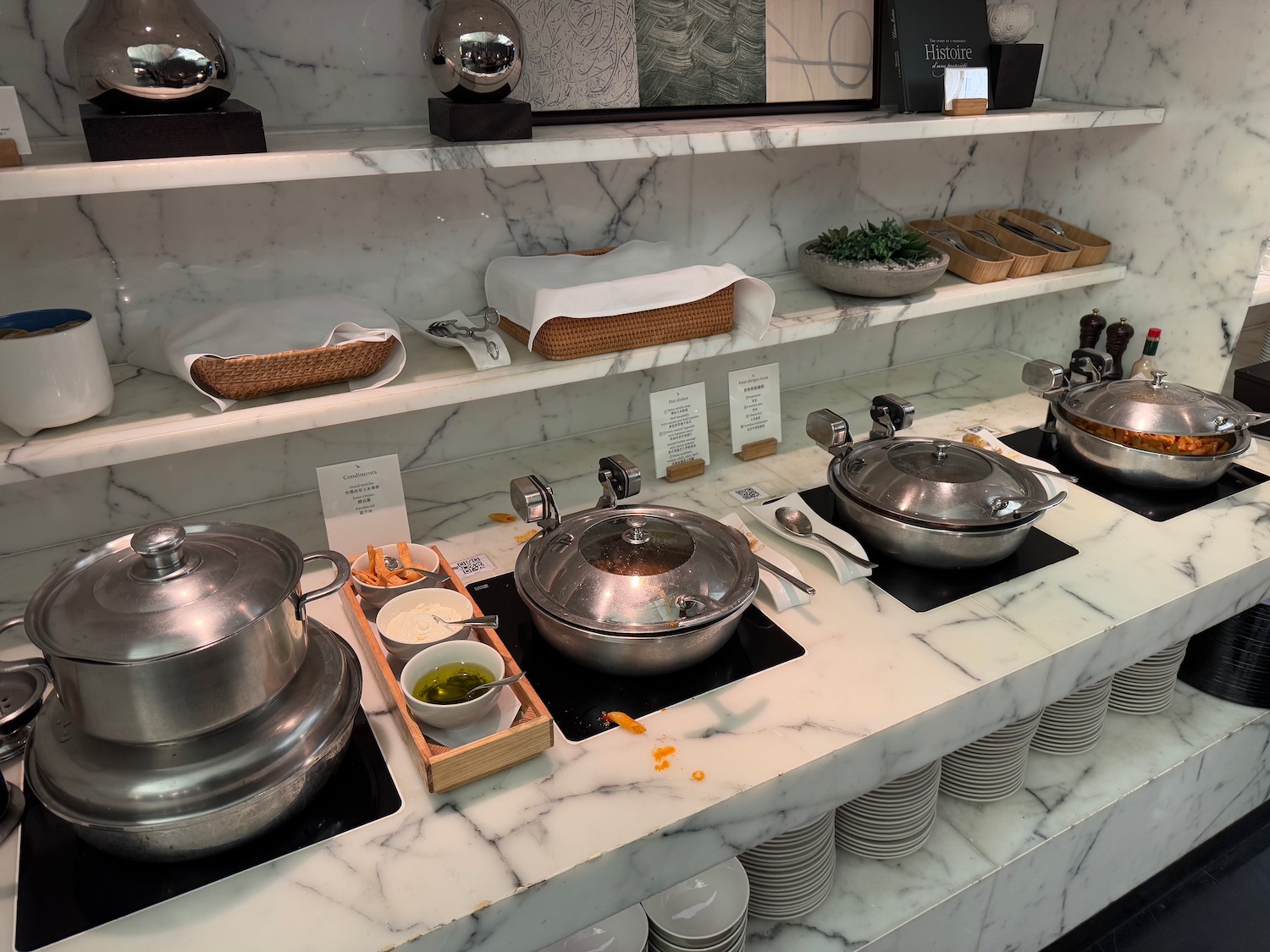 a counter with silver bowls and bowls on it