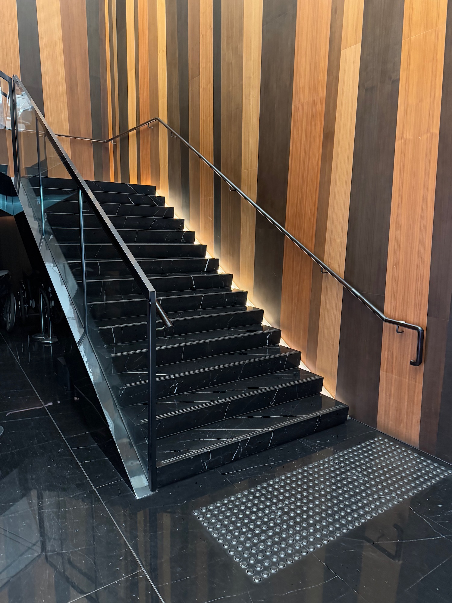 a black staircase with a glass railing