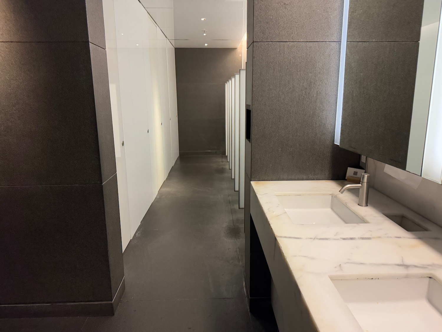 a bathroom with sinks and mirrors