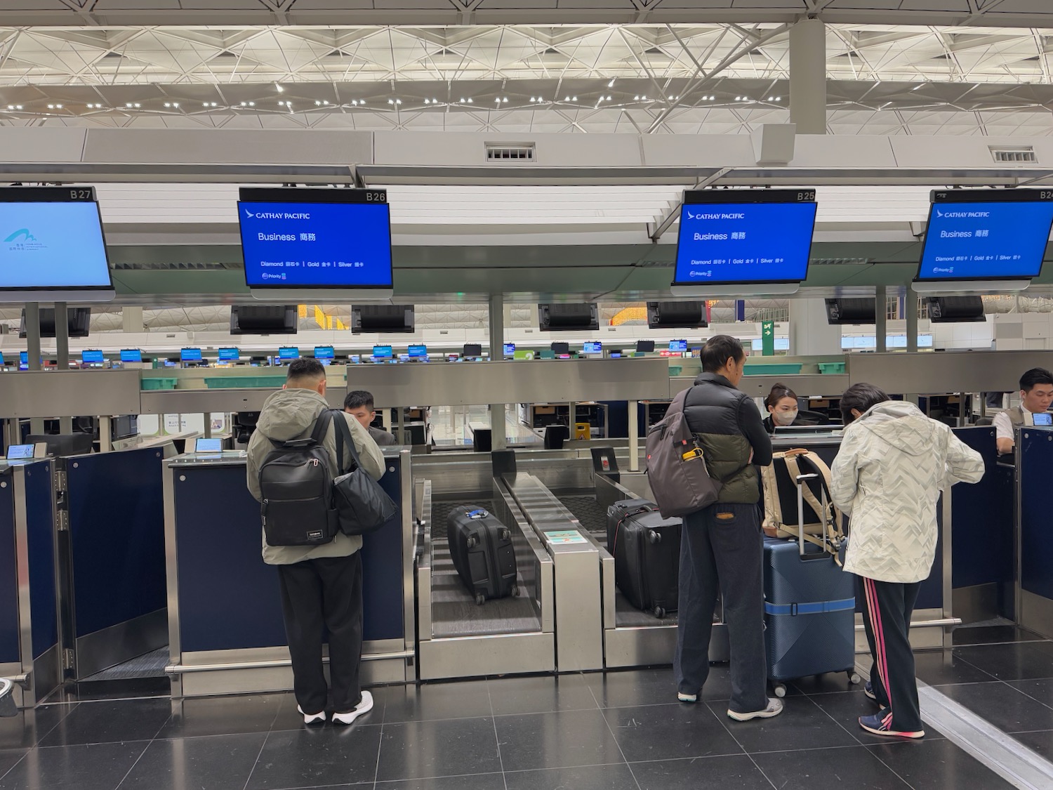 people standing in front of a conveyor belt