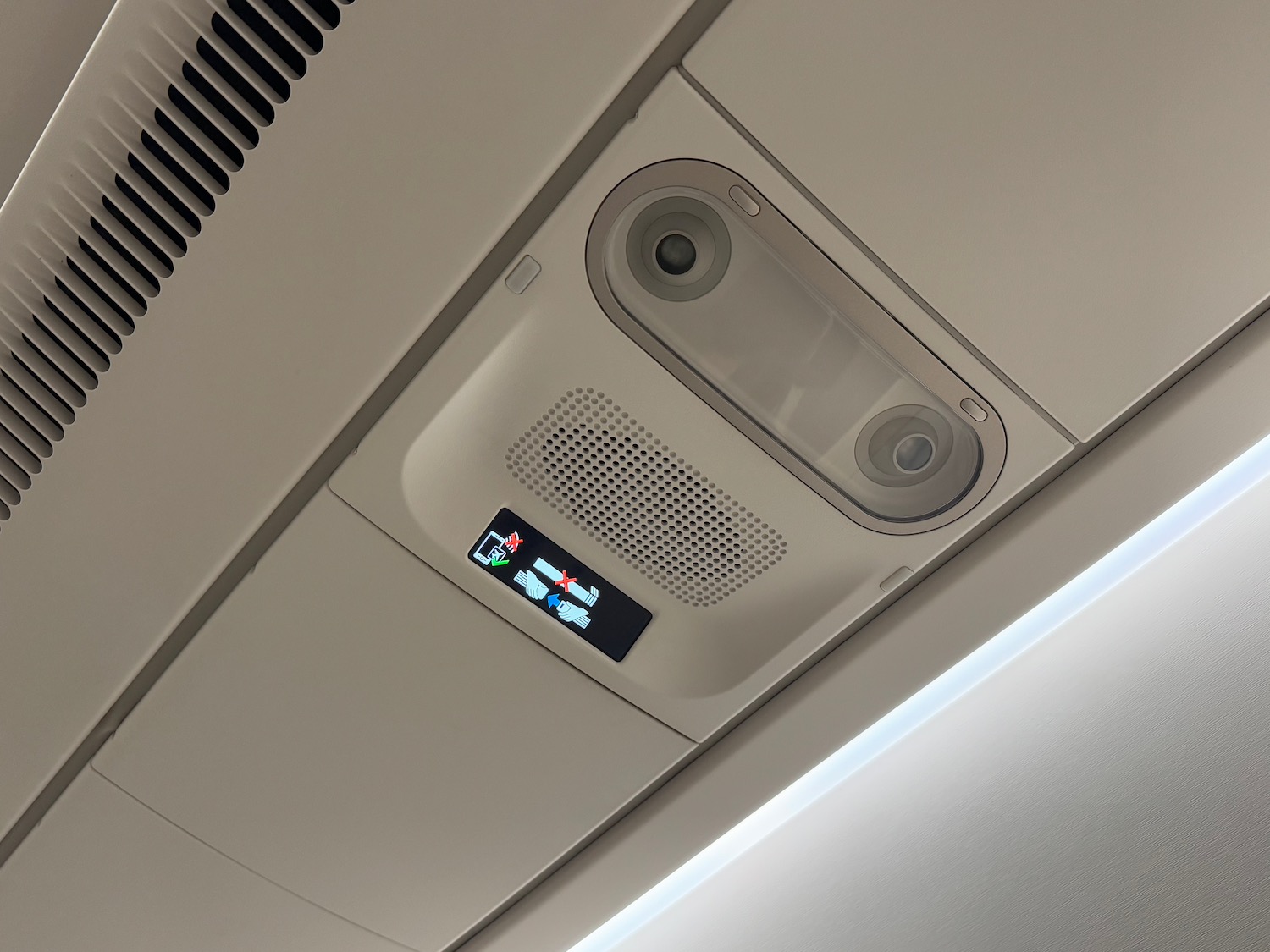 a ceiling with a speaker and a sign