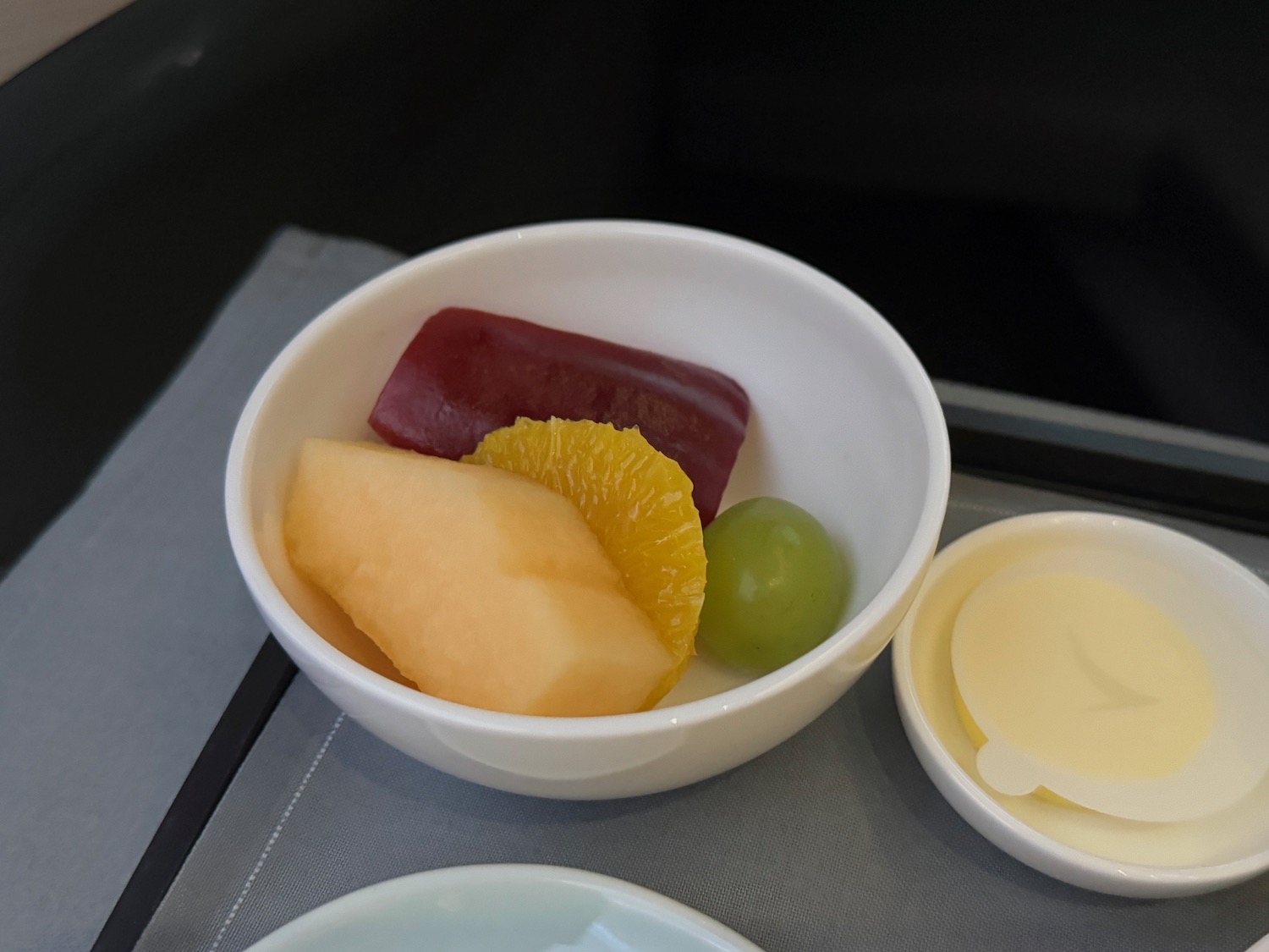 a bowl of fruit on a tray