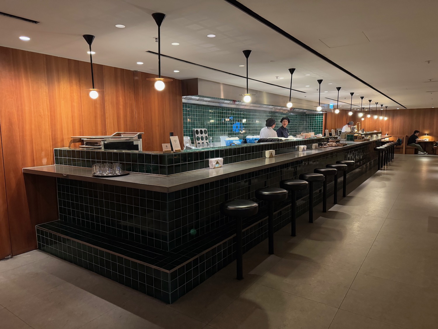 a restaurant with a counter and stools