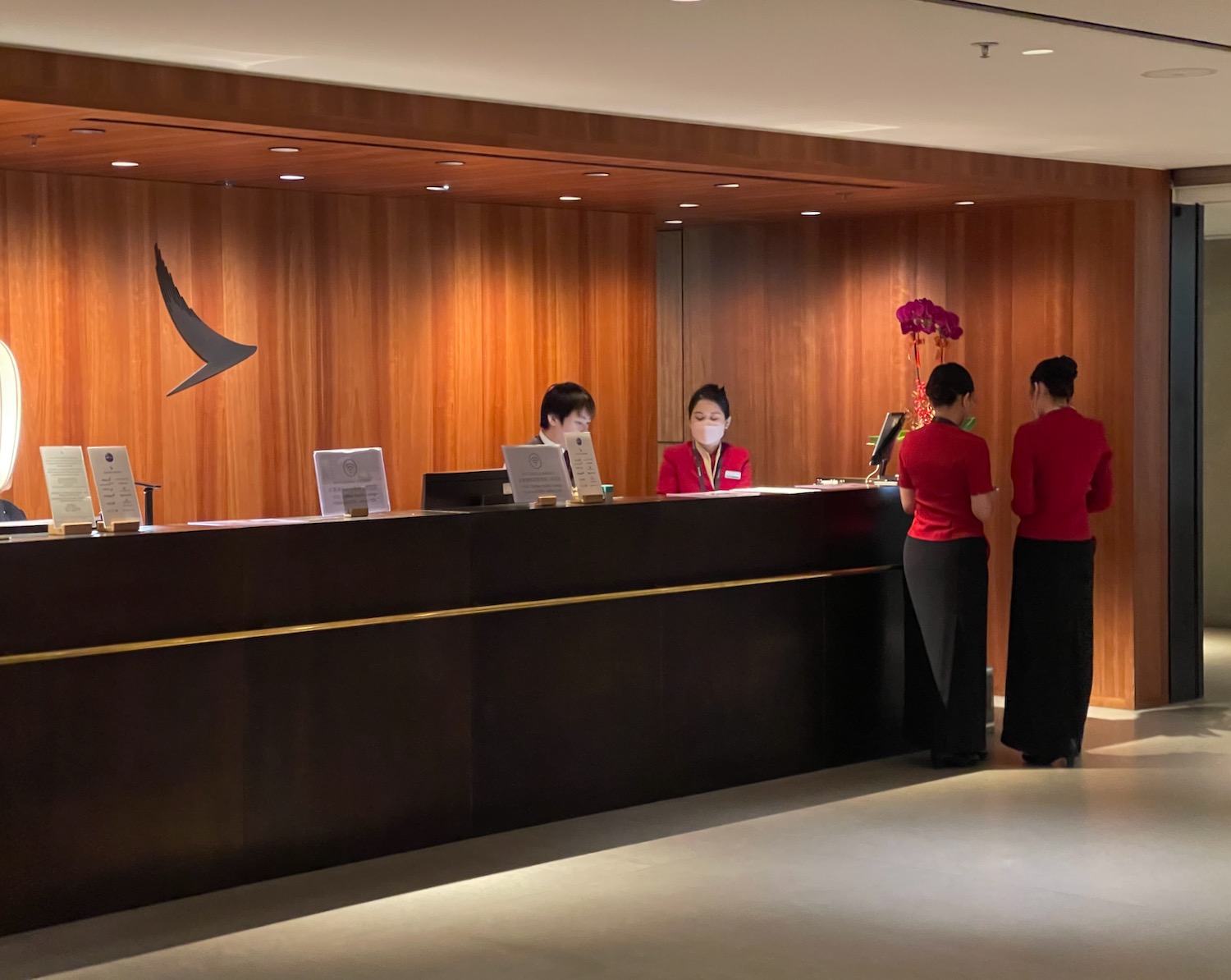a group of people standing at a reception desk