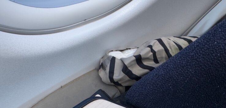 a striped pillow on a window
