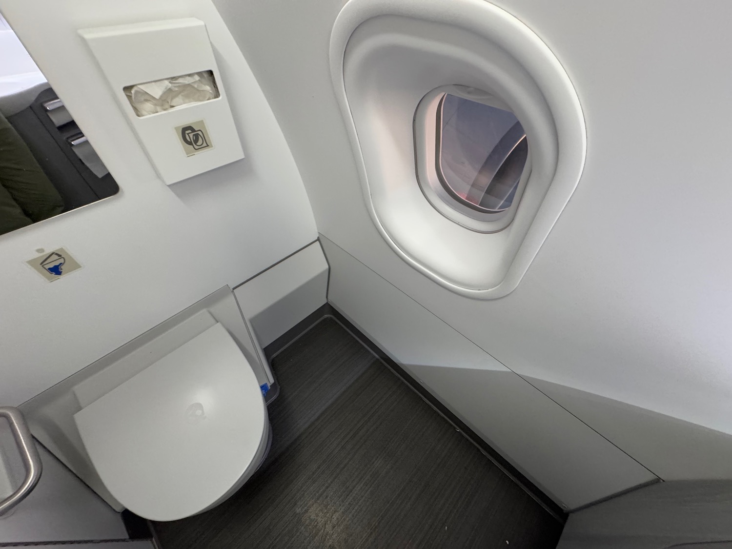 a toilet and a window in a plane