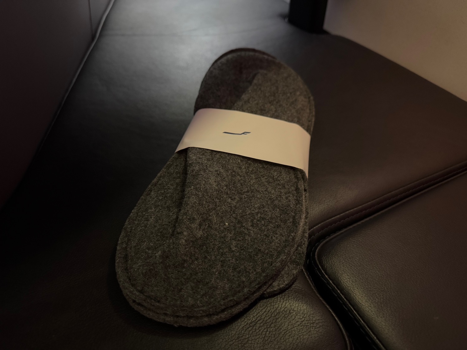 a pair of slippers on a leather chair