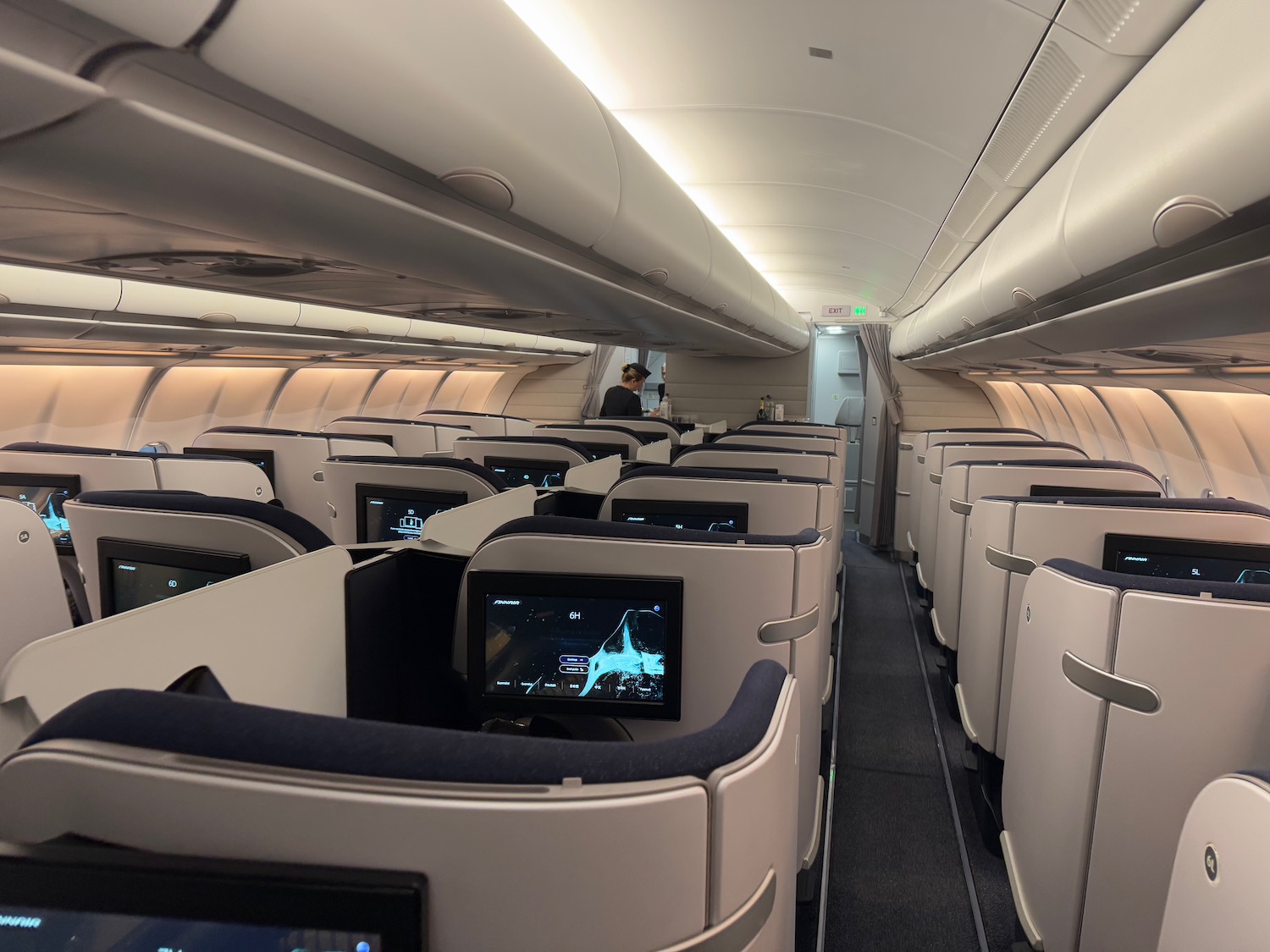 an airplane with rows of seats and monitors